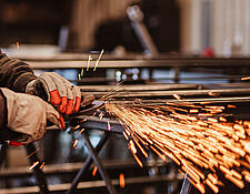 closeup of man's gloved hands welding