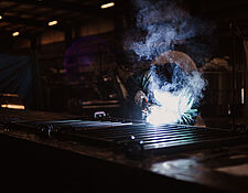 man welding in shop